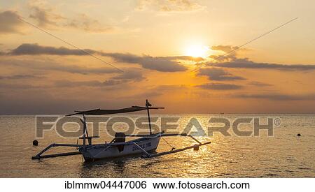 Stock Photograph - Sunset, outrigger canoe at sea, Lovina Beach, Bali, Indonesia, Asia. Fotosearch