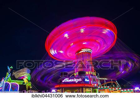 Swings carousel in motion, night scene, Oktoberfest, Munich, Bavaria, Germany, Europe View Large Photo Image Stock Photograph - Swings carousel in motion, night scene, Oktoberfest, Munich, Bavaria, Germany, Europe. Fotosearch