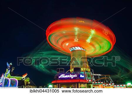 Swings carousel in motion, night scene, Oktoberfest, Munich, Bavaria, Germany, Europe View Large Photo Image Stock Photography - Swings carousel in motion, night scene, Oktoberfest, Munich, Bavaria, Germany, Europe. Fotosearch