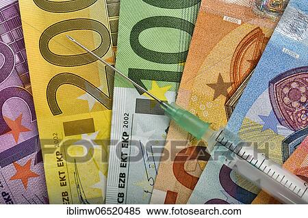 Symbolic picture Costs of mass vaccination against Covid-19, syringe lies on EURO banknotes, corona crisis, Baden-Württemberg, Germany, Europe View Large Photo Image Stock Photography - Symbolic picture Costs of mass vaccination against Covid-19, syringe lies on EURO banknotes, corona crisis, Baden-Württemberg, Germany, Europe. Fotosearch
