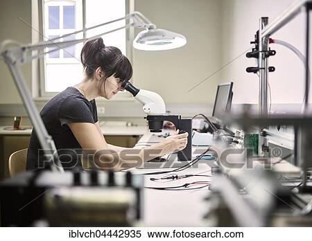 Technician, young woman using electronic microscope View Large Photo Image Stock Photography - Technician, young woman using electronic microscope. Fotosearch