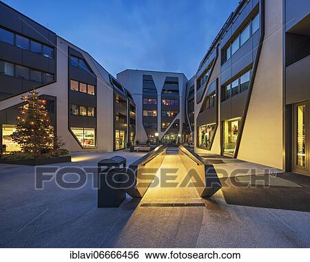 Stock Photograph - The Sonnenhof in the twilight with Christmas tree, office and residential building, modern architecture, Jena, Thuringia, Germany, Europe. Fotosearch