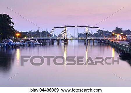 The Wieck Bridge in the port of Wieck, morning atmosphere, bascule Bridge over the River Ryck, Greifswald, Mecklenburg-Western Pomerania, Germany, Europe View Large Photo Image Stock Photo - The Wieck Bridge in the port of Wieck, morning atmosphere, bascule Bridge over the River Ryck, Greifswald, Mecklenburg-Western Pomerania, Germany, Europe. Fotosearch