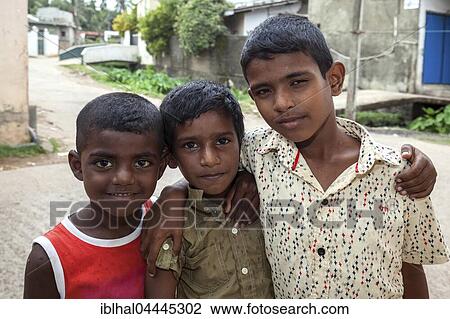 Stock Image - Three local boys, Sinhalese, Beruwela, Western Province, Sri Lanka, Asia. Fotosearch