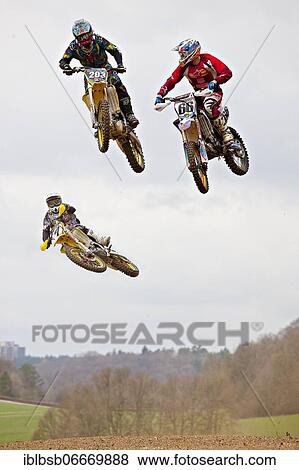 Three motocross machines in the air at the race, Schnaitheim, Baden-Württemberg, Germany, Europe View Large Photo Image Stock Photo - Three motocross machines in the air at the race, Schnaitheim, Baden-Württemberg, Germany, Europe. Fotosearch