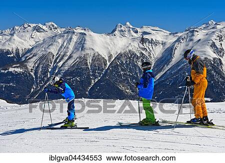 Three skiers against snowy Lepontine Alps, The Aletsch Arena, Riederalp, Valais Canton, ski resort, Switzerland, Europe View Large Photo Image Stock Image - Three skiers against snowy Lepontine Alps, The Aletsch Arena, Riederalp, Valais Canton, ski resort, Switzerland, Europe. Fotosearch