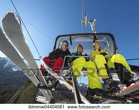 Three teenagers on chairlift with skis and snowboard, taking selfie, Spitzingsee ski resort, Bavaria, Germany, Europe View Large Photo Image Stock Image - Three teenagers on chairlift with skis and snowboard, taking selfie, Spitzingsee ski resort, Bavaria, Germany, Europe. Fotosearch