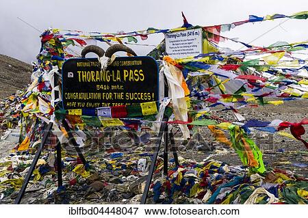 Stock Photo - Tibetan prayer flags at sign Thorong-La Pass, 5416 m, pass between the Upper Marsyangdi and the Kali Gandaki valley, Manang District, Nepal, Asia. Fotosearch