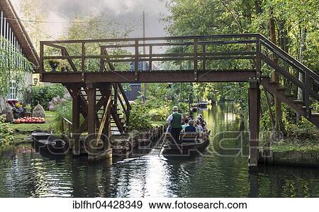 Stock Photo - Tourists in a Spreewald boat under bridge. Lübbenau, Spreewald, Brandenburg, Germany, Europe. Fotosearch