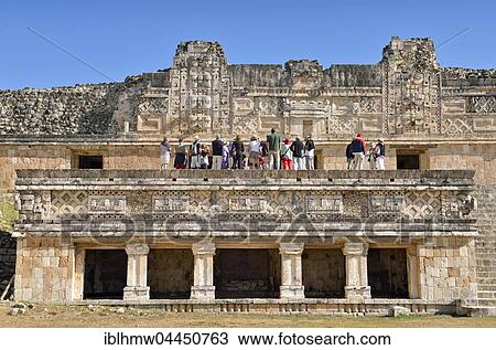 Stock Image - Tourists on Cuadrangulo de las Monjas, Nun's Quadrangle, ancient Mayan city of Uxmal, Yucatan, Mexico, Central America. Fotosearch