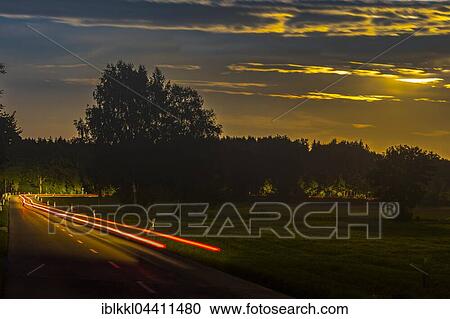 Stock Image - Tracer of a car at night, winding road, Allgäu, Bavaria, Germany, Europe. Fotosearch