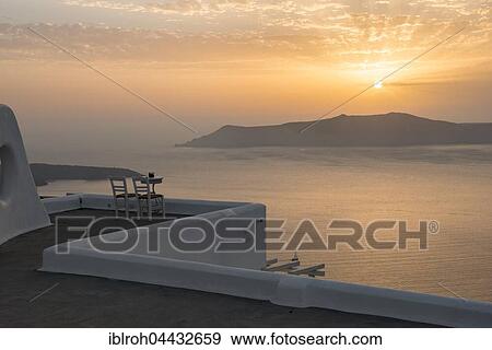 Two chairs on terrace, sunset, view of ocean, Firá, Santorini, Cyclades, Greece, Europe View Large Photo Image Stock Photo - Two chairs on terrace, sunset, view of ocean, Firá, Santorini, Cyclades, Greece, Europe. Fotosearch