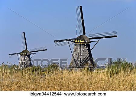 Two Dutch windmills, UNESCO World Heritage Site Kinderdijk, Alblasserwaard polder, South Holland, The Netherlands, Europe View Large Photo Image Picture - Two Dutch windmills, UNESCO World Heritage Site Kinderdijk, Alblasserwaard polder, South Holland, The Netherlands, Europe. Fotosearch