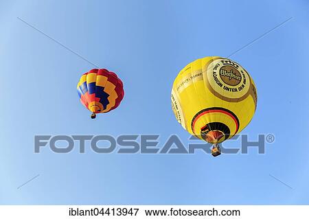 Two hot air balloons rising into the air, hot air balloon festival, 26th international Warsteiner Montgolfiade, Warstein, Sauerland, North Rhine-Westphalia, Germany, Europe View Large Photo Image Stock Photo - Two hot air balloons rising into the air, hot air balloon festival, 26th international Warsteiner Montgolfiade, Warstein, Sauerland, North Rhine-Westphalia, Germany, Europe. Fotosearch