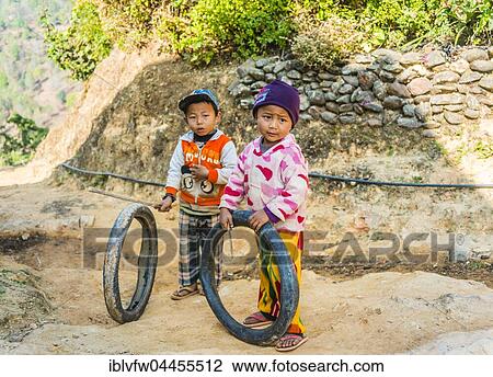 Two little boys with tires as toys, Palaung hilltribe, Palaung Village in Kyaukme, Shan State, Myanmar, Asia View Large Photo Image Stock Image - Two little boys with tires as toys, Palaung hilltribe, Palaung Village in Kyaukme, Shan State, Myanmar, Asia. Fotosearch