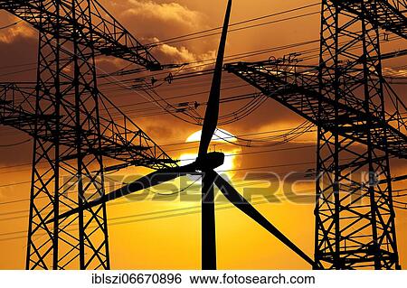 Two overhead line pylons and a wind turbine in front of the sun, Witten, Ruhr area, North Rhine-Westphalia, Germany, Europe View Large Photo Image Stock Photograph - Two overhead line pylons and a wind turbine in front of the sun, Witten, Ruhr area, North Rhine-Westphalia, Germany, Europe. Fotosearch