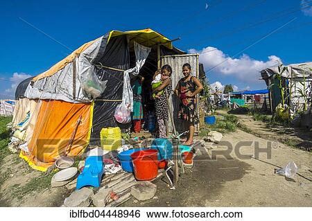 Two women, one carrying baby, standing in front of tent, camp for people who lost homes in 2015 earthquake, Boudha suburb, Kathmandu, Kathmandu District, Nepal, Asia View Large Photo Image Stock Photograph - Two women, one carrying baby, standing in front of tent, camp for people who lost homes in 2015 earthquake, Boudha suburb, Kathmandu, Kathmandu District, Nepal, Asia. Fotosearch