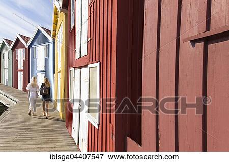 Two women walking next to fishing huts, Smögen, Bohuslän, West Sweden, Sweden, Europe View Large Photo Image Stock Photo - Two women walking next to fishing huts, Smögen, Bohuslän, West Sweden, Sweden, Europe. Fotosearch