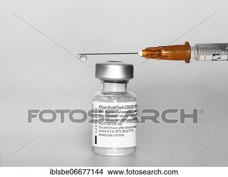 Vaccine vial against Covid 19 and syringe with drops, Biontech, Pfizer, Pfizer-BioNTech View Large Photo Image Picture - Vaccine vial against Covid 19 and syringe with drops, Biontech, Pfizer, Pfizer-BioNTech. Fotosearch