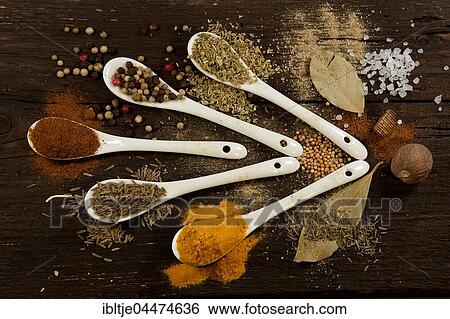 Various dried spices on small spoons, paprika, colorful peppercorns, basil, bay leaves, coarse salt, nutmeg, oregano, turmeric, cumin, mustard seeds View Large Photo Image Stock Photograph - Various dried spices on small spoons, paprika, colorful peppercorns, basil, bay leaves, coarse salt, nutmeg, oregano, turmeric, cumin, mustard seeds. Fotosearch