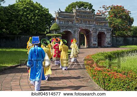 Vietnamese extras in traditional costumes going through West Gate, Chuong Duc, Imperial Palace Hoang Thanh, Forbidden City, Hue, Vietnam, Asia View Large Photo Image Stock Photo - Vietnamese extras in traditional costumes going through West Gate, Chuong Duc, Imperial Palace Hoang Thanh, Forbidden City, Hue, Vietnam, Asia. Fotosearch