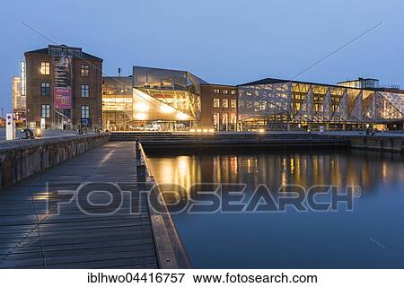 Stock Photo - View at dusk of The Culture Yard, a modern cultural center with library, designed by AART architects in Elsinore, Hovedstaden Region, Denmark, Europe. Fotosearch