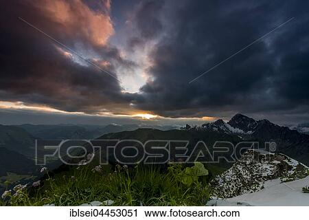 View from Zafernhorn at sunrise with dark clouds, stormy atmosphere, Alpine panorama, Allgäu Alps, Damüls, Bregenz Forest, Vorarlberg, Austria, Europe View Large Photo Image Stock Image - View from Zafernhorn at sunrise with dark clouds, stormy atmosphere, Alpine panorama, Allgäu Alps, Damüls, Bregenz Forest, Vorarlberg, Austria, Europe. Fotosearch