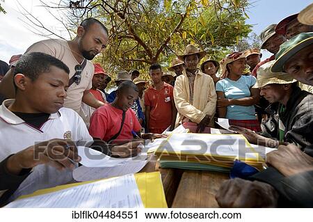 Villagers fill out applications for certification of their land on the village square, Analakely village, Tanambao commune, Tsiroanomandidy district, Bongolava region, Madagascar, Africa View Large Photo Image Stock Image - Villagers fill out applications for certification of their land on the village square, Analakely village, Tanambao commune, Tsiroanomandidy district, Bongolava region, Madagascar, Africa. Fotosearch