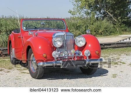 Stock Image - Vintage Triumph Roadster 2000, built in 1948, 4 cylinders, displacement 2000cc, 3 forward gears, 60 hp, 100 km/h, aluminum body. Fotosearch