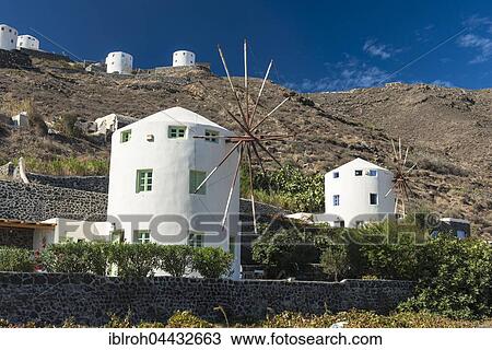 Stock Image - Windmills on hillside, Firá, Santorini, Cyclades, Greece, Europe. Fotosearch