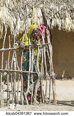 Woman at fence, mud hut, Orma settlement, Marafa, Tana River Delta, Kenya, Africa View Large Photo Image Stock Photo - Woman at fence, mud hut, Orma settlement, Marafa, Tana River Delta, Kenya, Africa. Fotosearch