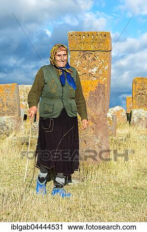 Woman at Medieval Khachkars, carved memorial stele, Noratus Cemetery, Lake Sevan, Gegharkunik Province, Caucasus, Armenia, Asia View Large Photo Image Stock Image - Woman at Medieval Khachkars, carved memorial stele, Noratus Cemetery, Lake Sevan, Gegharkunik Province, Caucasus, Armenia, Asia. Fotosearch