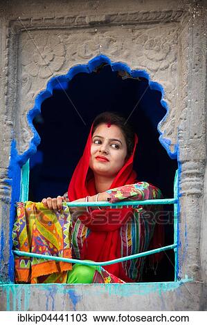 Woman in colorful sari looks out of a window, Jodhphur, Rajasthan, India, Asia View Large Photo Image Stock Image - Woman in colorful sari looks out of a window, Jodhphur, Rajasthan, India, Asia. Fotosearch
