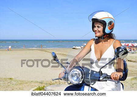 Woman on Vespa scooter, beach, Senigallia, Province of Ancona, Marche, Italy, Europe View Large Photo Image Picture - Woman on Vespa scooter, beach, Senigallia, Province of Ancona, Marche, Italy, Europe. Fotosearch