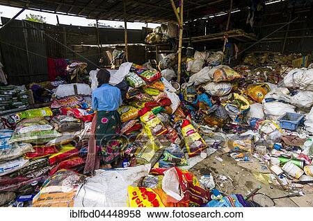 Stock Photo - Woman sorting out garbage in shelter for recycling, Kathmandu, Nepal, Asia. Fotosearch
