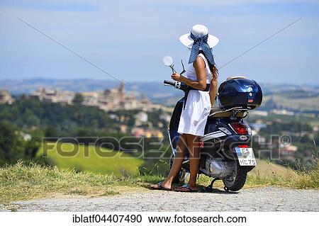 Woman with white sunhat next to Vespa Primavera scooter, Corinaldo, Marche, Italy, Europe View Large Photo Image Stock Image - Woman with white sunhat next to Vespa Primavera scooter, Corinaldo, Marche, Italy, Europe. Fotosearch