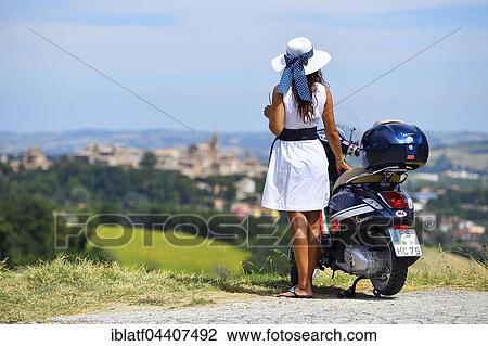 Woman with white sunhat next to Vespa Primavera scooter, Corinaldo, Marche, Italy, Europe View Large Photo Image Stock Image - Woman with white sunhat next to Vespa Primavera scooter, Corinaldo, Marche, Italy, Europe. Fotosearch