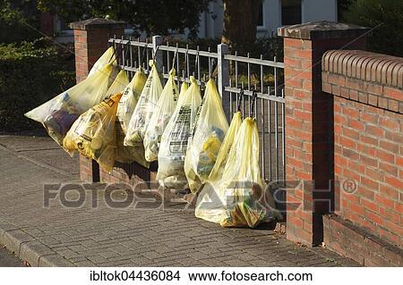 Yellow bags with plastic waste, hanging on garden fence, waste separation, Lower Saxony, Germany, Europe View Large Photo Image Picture - Yellow bags with plastic waste, hanging on garden fence, waste separation, Lower Saxony, Germany, Europe. Fotosearch