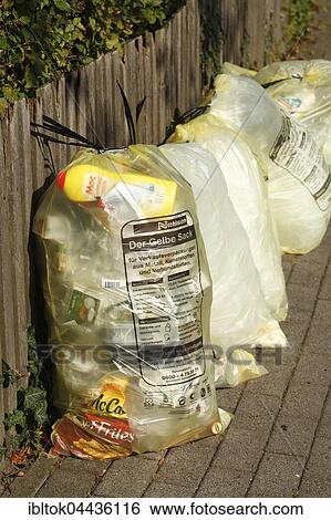 Yellow bags with plastic waste, hanging on garden fence, waste separation, Lower Saxony, Germany, Europe View Large Photo Image Stock Photograph - Yellow bags with plastic waste, hanging on garden fence, waste separation, Lower Saxony, Germany, Europe. Fotosearch