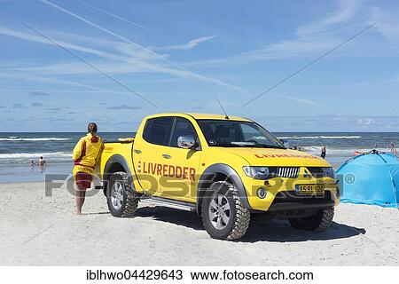 Stock Image - Yellow car with inscription Livredder on Henne Beach, water rescue service in use, Henne, Southern Denmark, The North Sea, Denmark, Europe. Fotosearch
