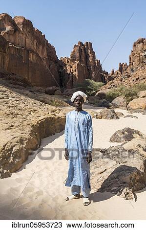 Young Beduin in traditional clothes at Guelta d'Archei waterhole, Ennedi plateau, Chad, Africa View Large Photo Image Stock Image - Young Beduin in traditional clothes at Guelta d'Archei waterhole, Ennedi plateau, Chad, Africa. Fotosearch