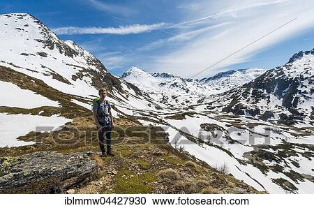Young man, hiker walking in mountain landscape with residual snow, Rohrmoos Obertal, Schladming Tauern, Schladming, Styria, Austria, Europe View Large Photo Image Stock Image - Young man, hiker walking in mountain landscape with residual snow, Rohrmoos Obertal, Schladming Tauern, Schladming, Styria, Austria, Europe. Fotosearch