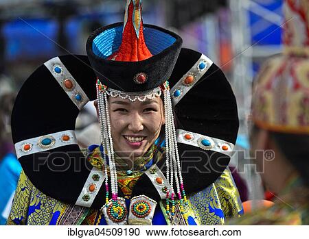 Stock Image - Young woman in traditional Deel clothes with hat, festival of the Mongolian national costume, Ulaanbaatar, Mongolia, Asia. Fotosearch