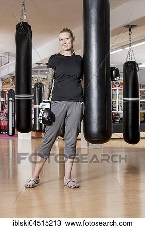 Young woman, tattooed, boxing at a sandsack in a boxing studio, Bavaria, Germany, Europe View Large Photo Image Stock Image - Young woman, tattooed, boxing at a sandsack in a boxing studio, Bavaria, Germany, Europe. Fotosearch