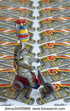 1950s tin toy, elephant on a scooter, with original 1949 tin printing plate, Emskirchem, Middle Franconia, Bavaria, Germany, Europe View Large Photo Image Stock Photo - 1950s tin toy, elephant on a scooter, with original 1949 tin printing plate, Emskirchem, Middle Franconia, Bavaria, Germany, Europe. Fotosearch