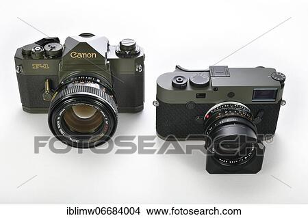 Picture - 50 years difference: limited edition special edition Canon F-1 ODF-1 in military olive drab finish from 1971, and limited edition Leica M10-P Reporter with Kevlar coating introduced in 2021, Germany, Europe. Fotosearch
