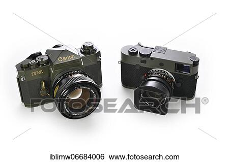 Stock Photograph - 50 years difference: limited edition special edition Canon F-1 ODF-1 in military olive drab finish from 1971, and limited edition Leica M10-P Reporter with Kevlar coating introduced in 2021, Germany, Europe. Fotosearch