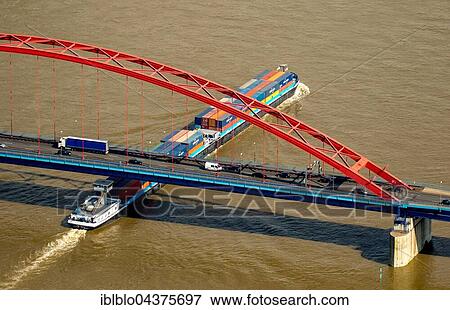 Aerial view, Cargo Ship, Container cargo ship on the Rhine during flood, the bridge of solidarity, Brücke der Solidarität, IWT, Duisburg, Ruhr district, North Rhine-Westphalia, Germany, Europe View Large Photo Image Stock Photo - Aerial view, Cargo Ship, Container cargo ship on the Rhine during flood, the bridge of solidarity, Brücke der Solidarität, IWT, Duisburg, Ruhr district, North Rhine-Westphalia, Germany, Europe. Fotosearch