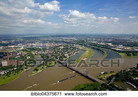 Stock Image - Aerial view, Cargo ships on the Rhine, brown flood mixes with the clean water of the Ruhr, Ruhr estuary, Duisburg, Ruhr district, North Rhine-Westphalia, Germany, Europe. Fotosearch