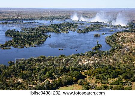 Aerial View, Zambezi river flows into the Victoria Falls, border of Zambia and Zimbabwe, Africa View Large Photo Image Stock Image - Aerial View, Zambezi river flows into the Victoria Falls, border of Zambia and Zimbabwe, Africa. Fotosearch